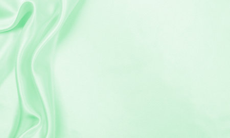 Smooth elegant green silk or satin luxury cloth texture can use as abstract background. Luxurious background designの写真素材