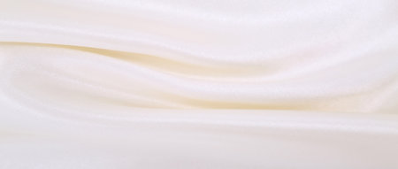 Smooth elegant white silk or satin luxury cloth texture can use as wedding background. Luxurious background designの写真素材