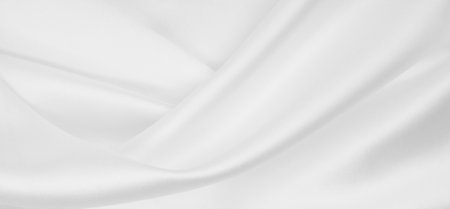 Smooth elegant white silk or satin luxury cloth texture can use as wedding background. Luxurious background designの写真素材