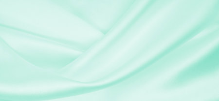 Smooth elegant green silk or satin luxury cloth texture can use as abstract background. Luxurious background designの写真素材
