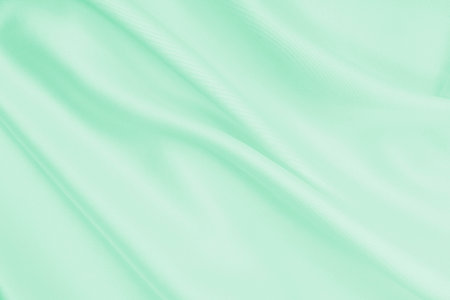 Smooth elegant green silk or satin luxury cloth texture can use as abstract background. Luxurious background designの写真素材