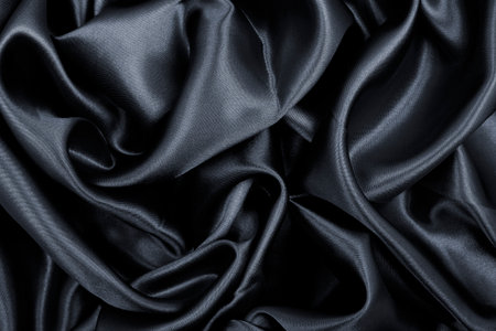 Smooth elegant black silk or satin texture can use as abstract background. Luxurious background designの写真素材