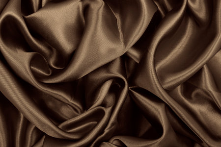 Smooth elegant brown silk or satin texture can use as abstract background. Luxurious background design. Sepia toned. Retro styleの写真素材