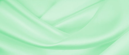 Smooth elegant green silk or satin luxury cloth texture can use as abstract background. Luxurious...
