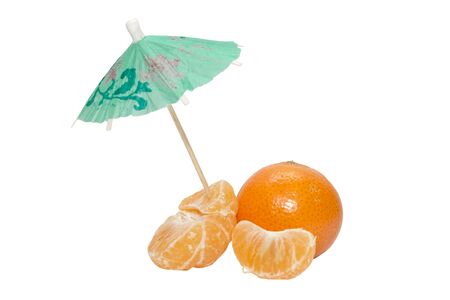 Tangerines and mandarin cloves with the umbrella on white backgroundの写真素材