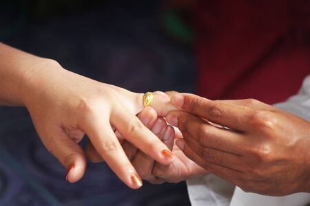 Close up Groom Put the Wedding Ring on brideの写真素材