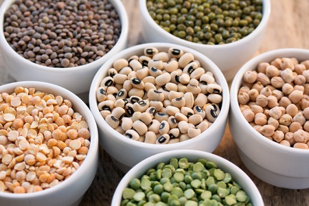 six bowls with cereals (bean  pea lentil haricot kidney) on wooden desk set in a circular, close-up, crop.の写真素材
