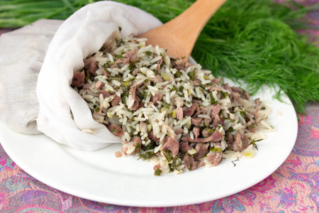 Uzbek traditional dish green pilaf in bag on white plate. Classic central asian Bukharian jewish cuisine.の写真素材