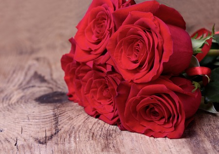 Bouquet of  red roses for valentine\'s day on wooden background. Closeup.の写真素材
