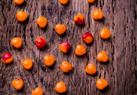 Valentines day background. Orange, red heart shaped pills or candy on vintage wooden background.の写真素材