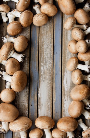 Fresh portobello mushrooms on rustic wooden desk, with blank area for copyspace.の写真素材