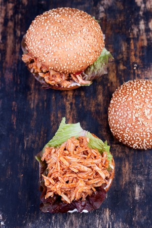 Freshly prepared sloppy joe sandwich on rustic black bakery peel.の写真素材