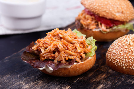 Freshly prepared sloppy joe sandwich on rustic black bakery peel.