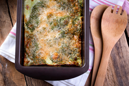 Spinach Lasagna in cooking form. Top view. Rustic wooden background.の写真素材