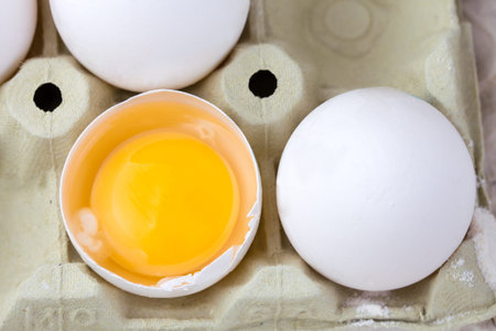 Whole and broken Fresh Eggs in egg carton