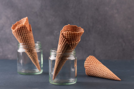 Empty ice cream cone. Blue background. Space for text