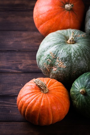 Autumn still life with pumpkins and flowers. Autumn Pumpkin Thanksgiving Background - pumpkins over wooden tableの写真素材