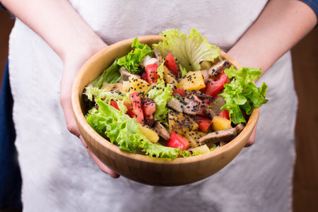 Meat salad on wooden table