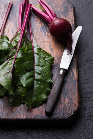 Raw beetroot on a cutting board on wooden backgroundの写真素材