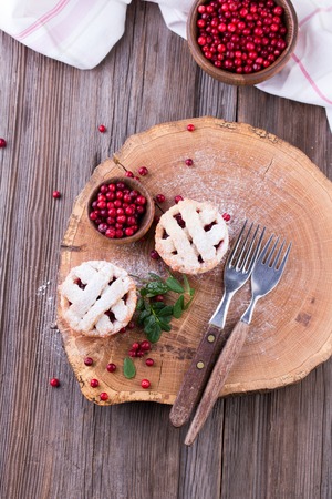 Homemade tartlet with cranberries on wooden table.の写真素材