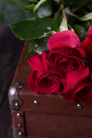 Red roses on wooden planks.の写真素材