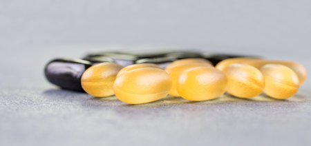 Fish oil, soft capsule, omega, supplement on wooden table background, healthy product conceptの写真素材