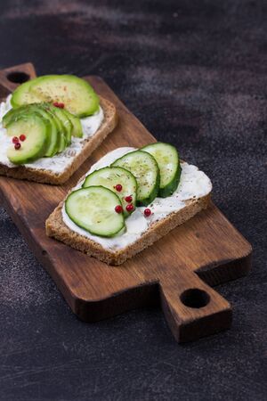 set healthy sandwiches with cucumber and avocado on dark background. Healthy eating concept.の写真素材