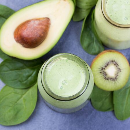 Blended green smoothie with ingredientsの写真素材
