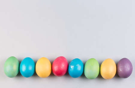 Colorful pastel easter eggs on grey background.の写真素材