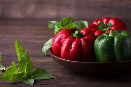 Fresh organic bell peppers on a wooden boardの写真素材
