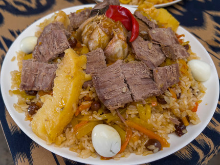 Pilaf with meat and vegetables in a plate on a tableの写真素材