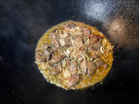 Fried meat with onions and spices in a wok. Selective focusの写真素材