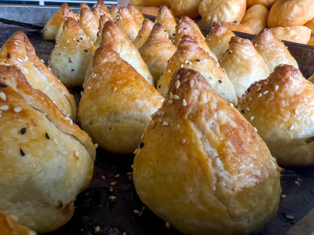 Fried pastry stuffed with cheese and sesame on a black backgroundの写真素材