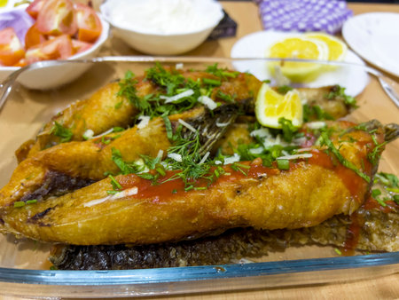 Fried fish with tomato sauce on a glass plate.の写真素材
