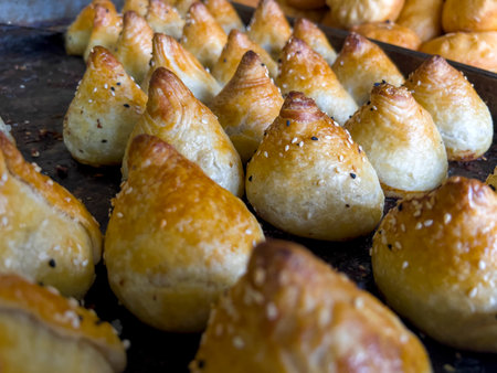 Sausage pastries on a baking sheet, close-upの写真素材