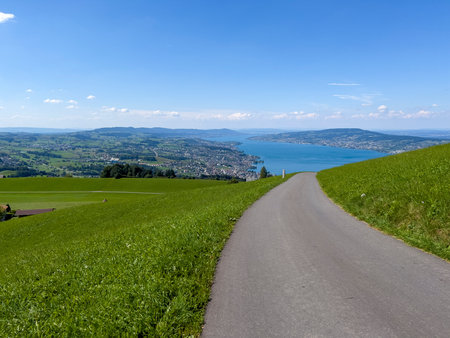 The narrow street leads down to a lake.の写真素材