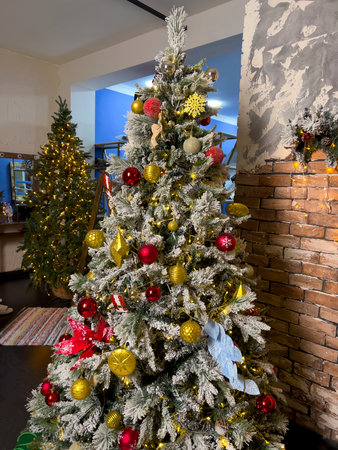 Decorated Christmas tree in the living room with a brick wallの写真素材
