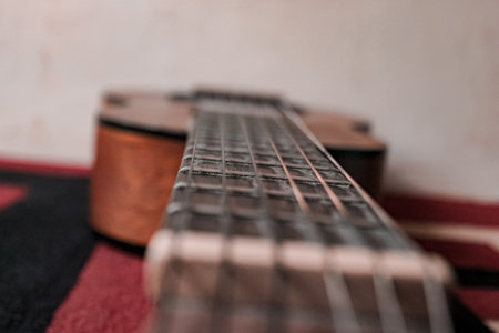 Small brown wooden acoustic guitar