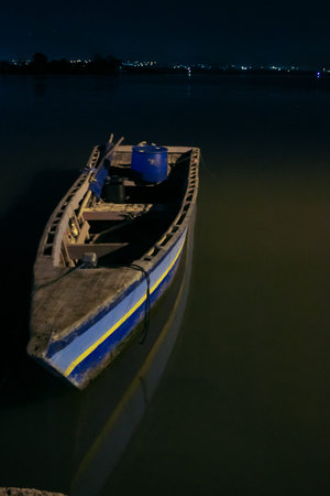 The boat that is leaning on the harbor by the beachの写真素材