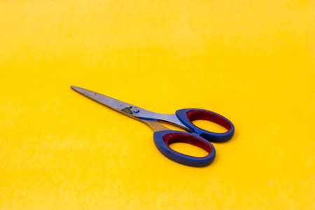 Scissors on a yellow backgroundの写真素材