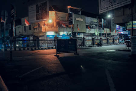 Lampung, Indonesia - August 4, 2021 : The atmosphere on an urban street at night in Lampung, Indonesia.のeditorial素材