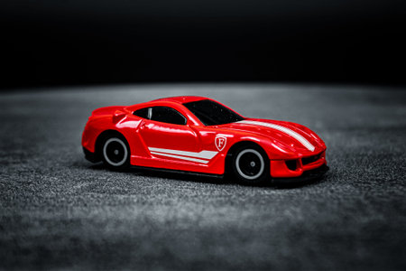 Close-up view of a children's toy car on a black background photographed indoors.