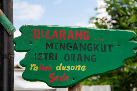 The warning board in the park with Indonesian writing