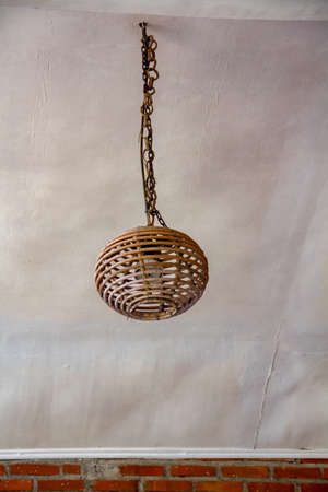 The design of the lamp made of woven rattan rods which is placed on the terrace of the houseの写真素材