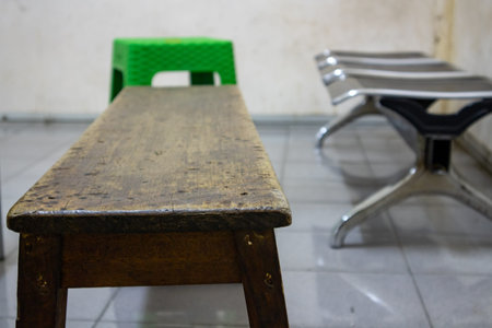 Wooden chairs in the room against a background of stainless chairs and plastic chairs