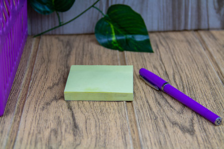 A notebook with a pen sitting on a wooden tableの写真素材