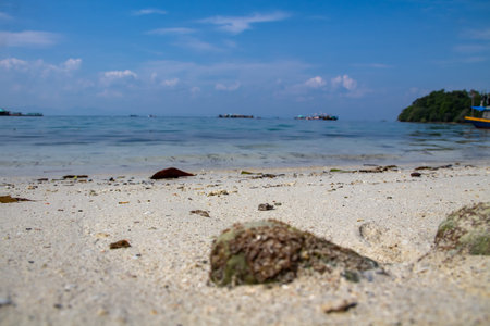 Background of sand, sea water and blue clouds on the beach