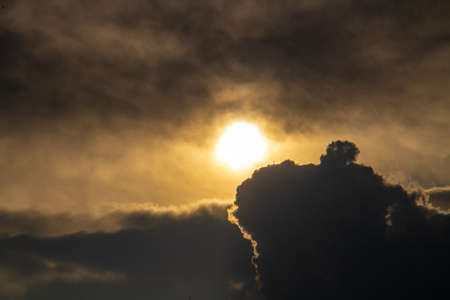 Orange sunset background with black cloudsの写真素材