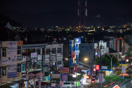 Photos of buildings decorated with lights at night in the middle of the cityの写真素材