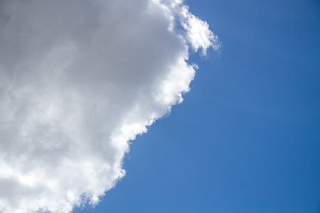 Textured background of white and blue clouds visible during the dayの写真素材